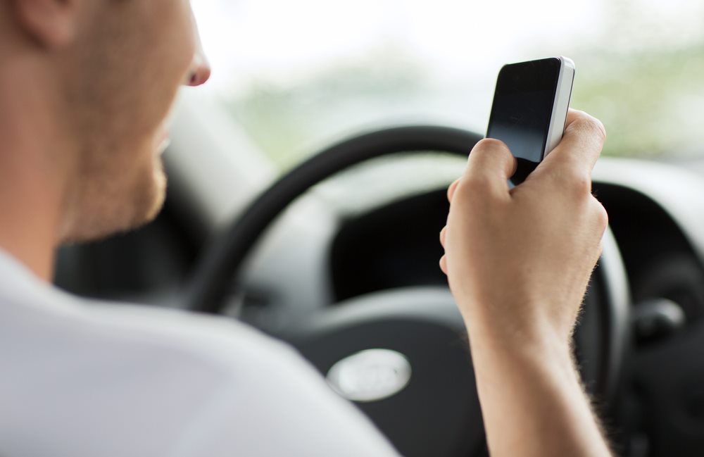 Accident Law Group, man texting and driving, man on social media and driving, Dangerous driving habits
